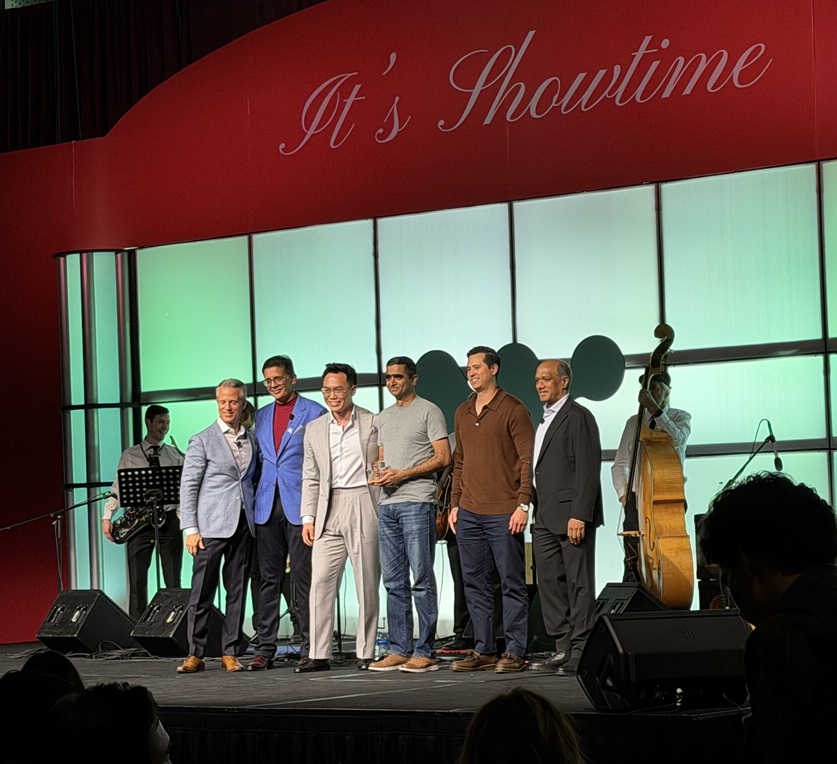 OneSolve accepting the Innovation Partner of the Year award on stage at Workato's 2026 SKO